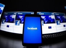 The loading screen of the Facebook application on a mobile phone is seen in this photo illustration taken in Lavigny May 16, 2012. Facebook Inc increased the size of its initial public offering by almost 25 percent, and could raise as much as $16 billion as strong investor demand for a share of the No.1 social network trumps debate about its long-term potential to make money. Facebook, founded eight years ago by Mark Zuckerberg in a Harvard dorm room, said on Wednesday it will add about 84 million shares to its IPO, floating about 421 million shares in an offering expected to be priced on Thursday. REUTERS/Valentin Flauraud (SWITZERLAND - Tags: BUSINESS SCIENCE TECHNOLOGY SOCIETY TPX IMAGES OF THE DAY) - RTR325LC