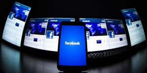 The loading screen of the Facebook application on a mobile phone is seen in this photo illustration taken in Lavigny May 16, 2012. Facebook Inc increased the size of its initial public offering by almost 25 percent, and could raise as much as $16 billion as strong investor demand for a share of the No.1 social network trumps debate about its long-term potential to make money. Facebook, founded eight years ago by Mark Zuckerberg in a Harvard dorm room, said on Wednesday it will add about 84 million shares to its IPO, floating about 421 million shares in an offering expected to be priced on Thursday. REUTERS/Valentin Flauraud (SWITZERLAND - Tags: BUSINESS SCIENCE TECHNOLOGY SOCIETY TPX IMAGES OF THE DAY) - RTR325LC